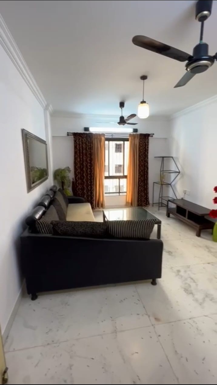 1 BHK fully furnished flat in Oshiwara with parking Spacious living room in 1 BHK Oshiwara apartment Bedroom of fully furnished 1 BHK flat in Oshiwara