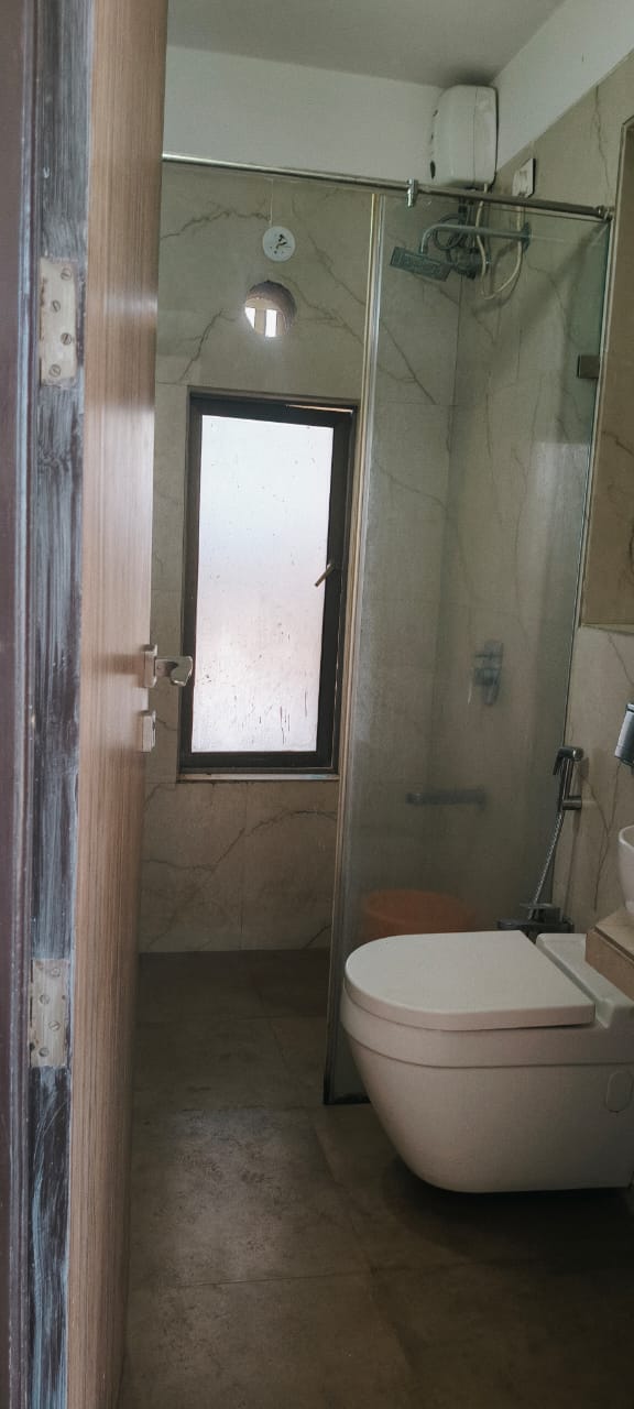 Spacious master bedroom with wardrobe and bed in single occupancy 2 BHK Andheri West